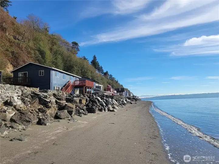 A true beach house right on the beach! Concrete steps built into the bulkhead for easy beach access.