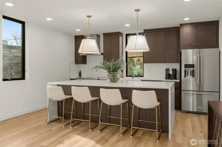 Oversized kitchen island with quartz waterfall