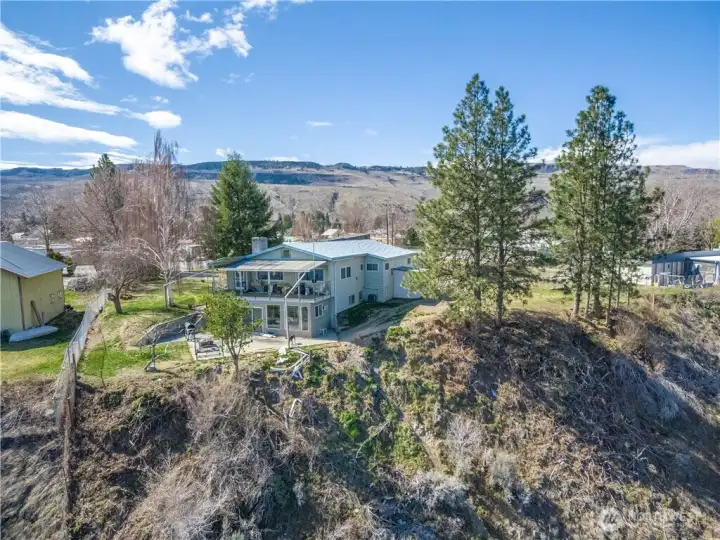 Back side of the house looking from north to south...sunroom on lower level and deck above on main level.