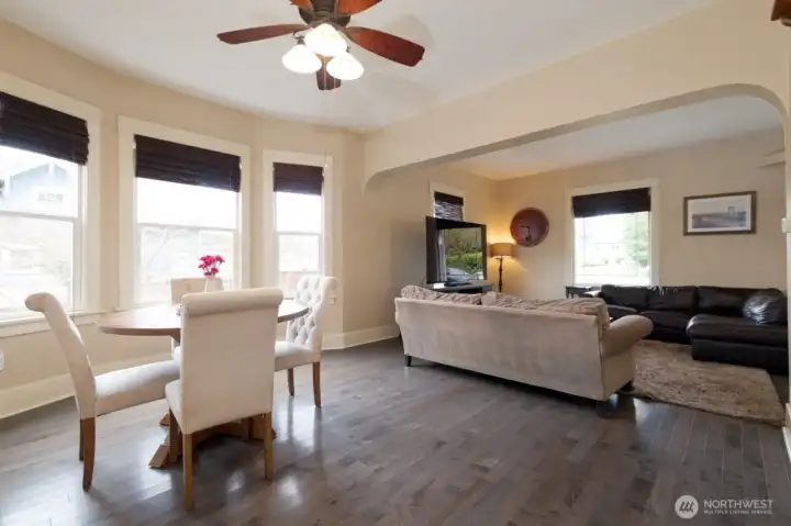 Open-concept living room flows seamlessly into the dining area, creating a bright and connected main living space.