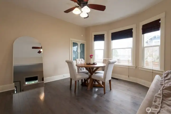 Open-concept living room transitions effortlessly into the dining space, enhancing natural light and functional flow.