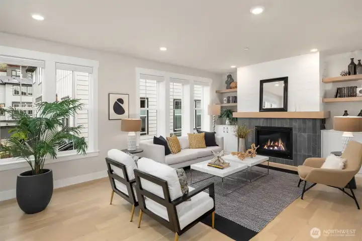 Inviting living room anchored by a custom fireplace feature wall with built-in shelving.