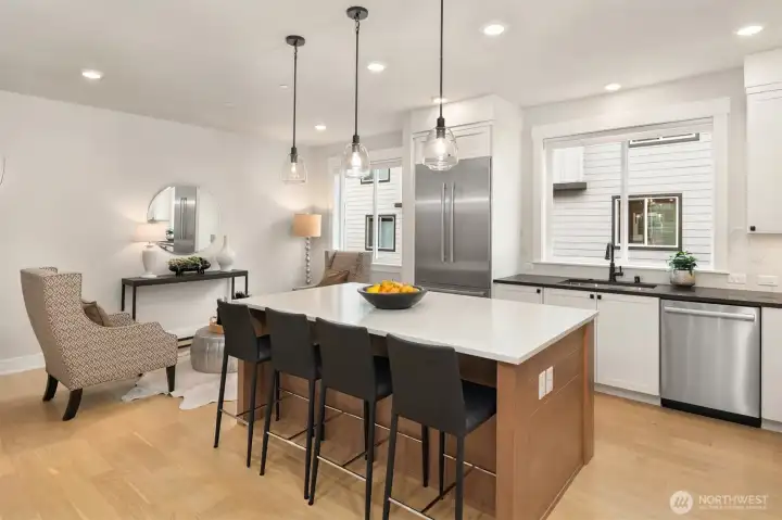 Seamless connection between kitchen, dining, and living areas enhances the home’s open layout.
