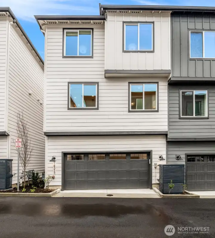 Modern farmhouse exterior with spacious two-car garage and bonus storage.