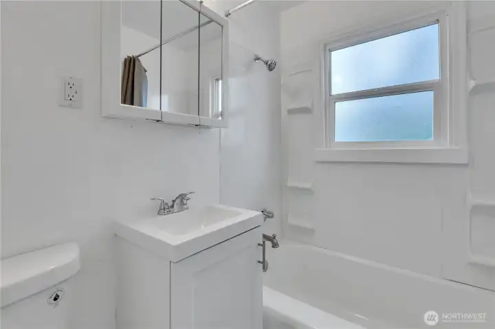 Downstairs bathroom with bathtub/shower combo.