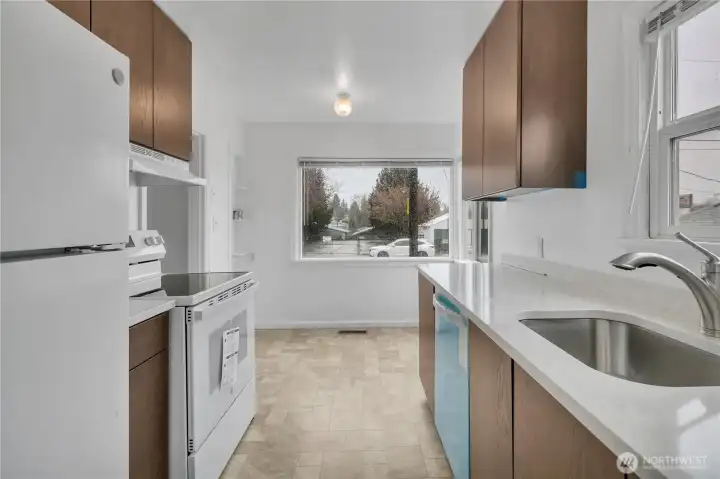 Kitchen with protective plastic cover on the brand new dishwasher.