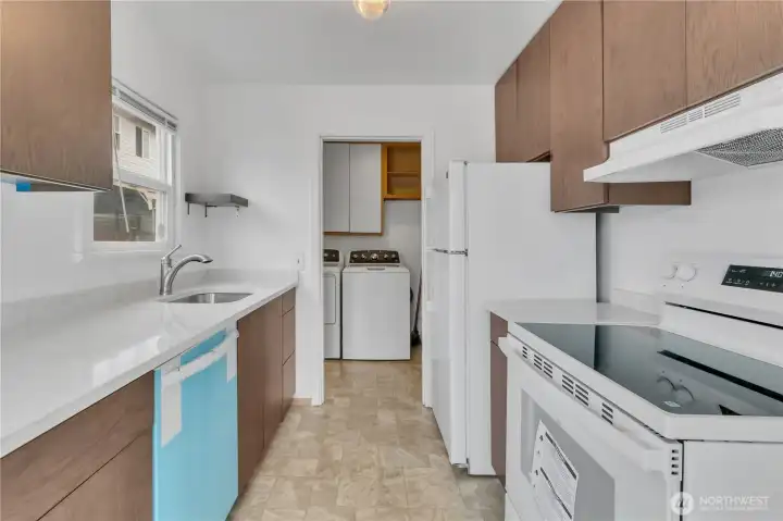 Kitchen with protective cover on the new dishwasher.