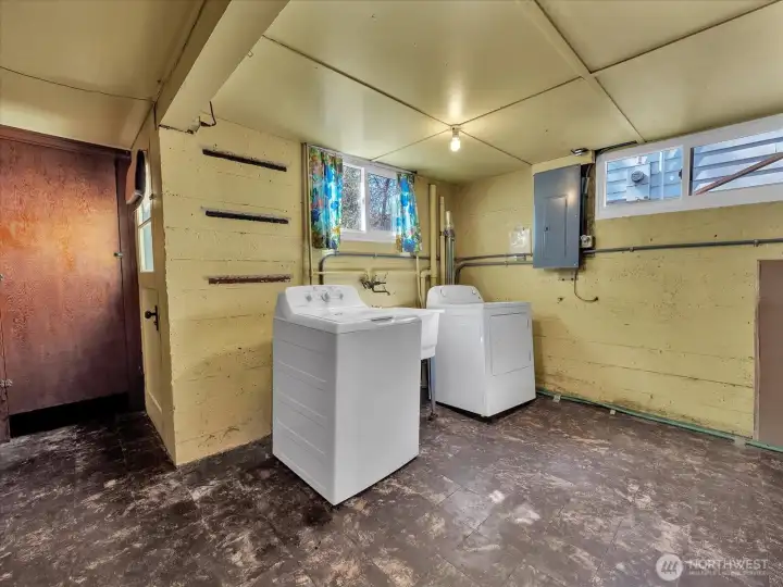 Laundry room with extra storge and an exit to the backyard.