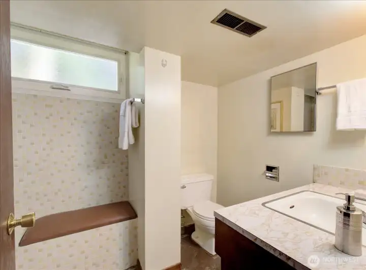 Spacious basement full bath with a little seating area.
