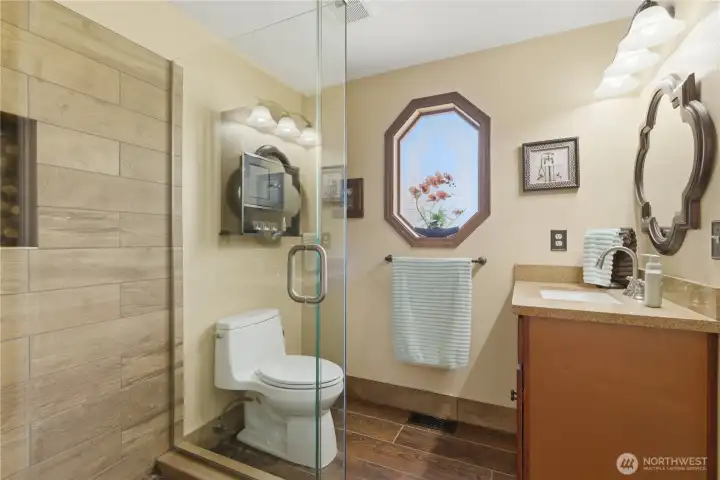 Recently updated 3/4 bath on the main level has access from the den or laundry room.