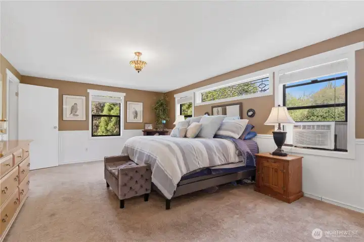 Primary bedroom has an abundance of natural light.  Please ask about the very special window above the headboard!