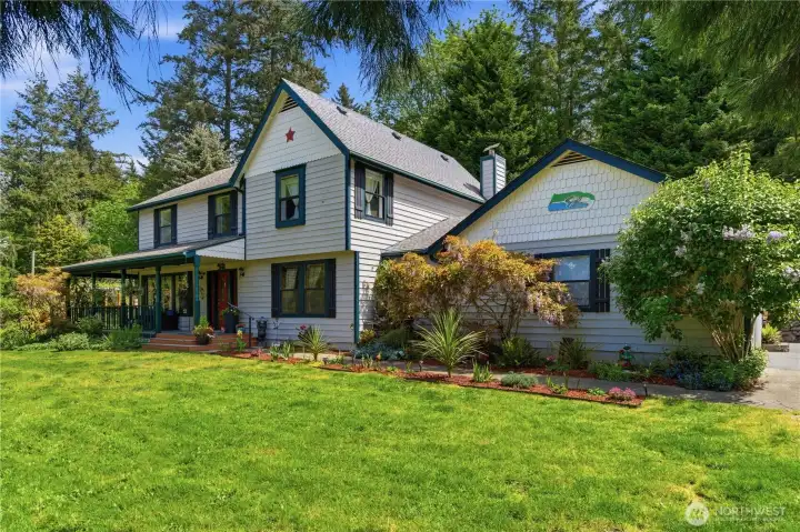 View of the front of the home.  There is lots of parking in the two car garage and surrounding paved areas.  Even room for your RV or Boat.