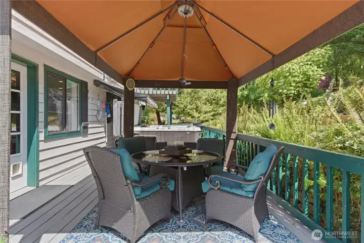 Dine alfresco but be protected by the awning!  Enjoy to lush foliage and open space beyond.