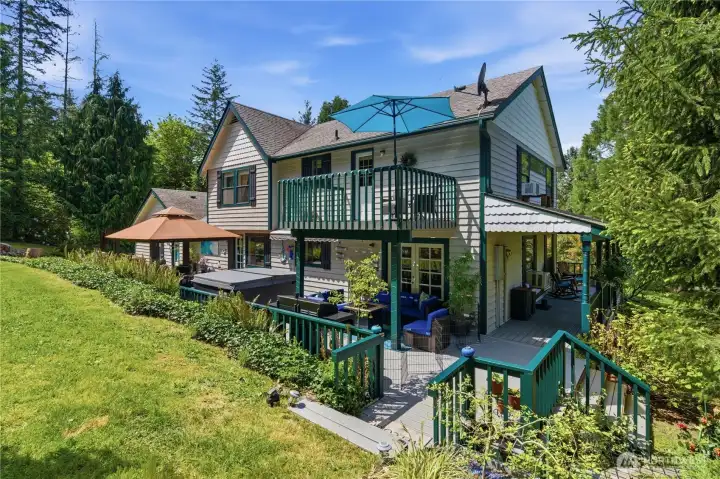 View of the rear of this home. Wrap around decking with so many options to relax and be One with nature.