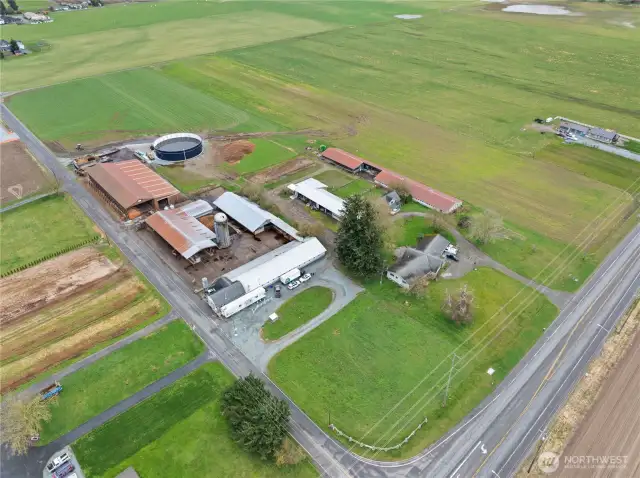 Aerial view of this established 20 acre dairy farm w/ 3 homes & a milk processing plant