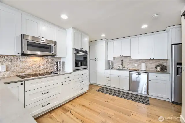 Wide open kitchen ,new cabinetry, lots of storage, concrete counters, tile backsplash Maytag s/s appliances
