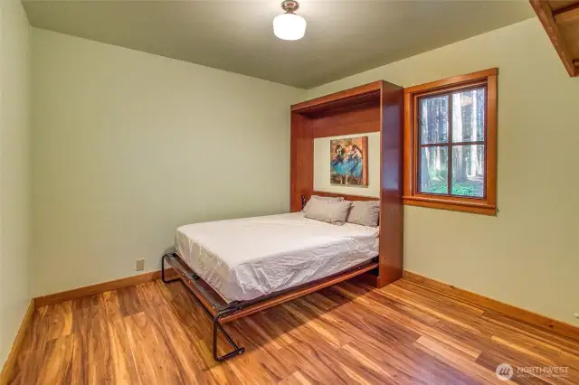 Murphy bed in one of two main floor bedrooms allows for flexible use of space.