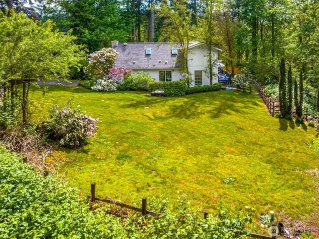 Large side yard visible from the private deck off the primary bedroom.