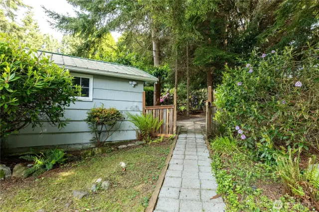 Charming detached garage offers potential for a studio, workshop, or storage—tucked into a garden setting.