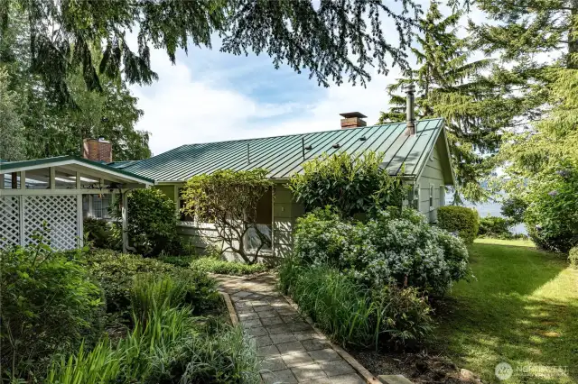 A peaceful forest path welcomes you to this island retreat—surrounded by rhododendrons and evergreens.