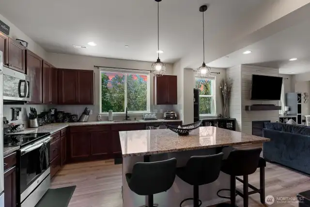 Open kitchen with granite topped island for cooking and socializing.
