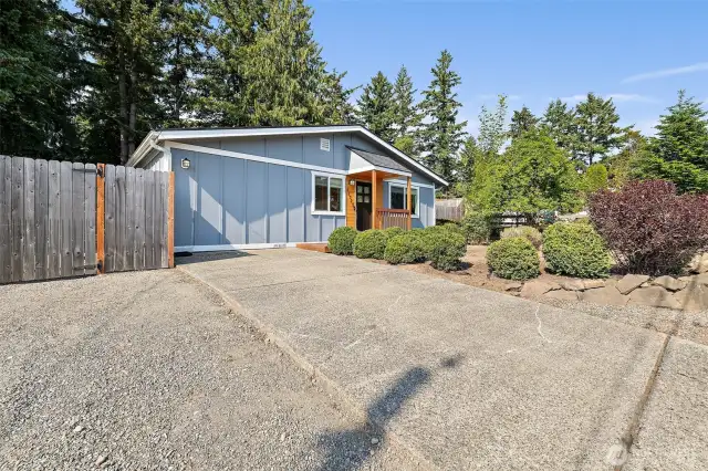 Parking in the driveway and front gate access to backyard.