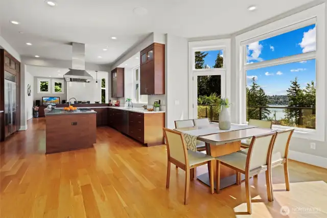 The breakfast nook has glass door to the deck and abundant natural light through the wall of windows looking out on the western lake views.