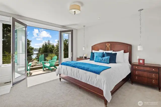 Spacious primary bedroom opening up onto a private balcony