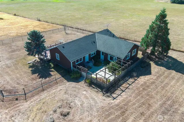 Home Sweet Home! Aerial Birdseye view of the home and fenced area surrounding the home.