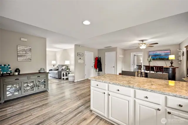 Designer paint, modern laminate flooring, and updated kitchen with granite - this is a great space.  A large dining table would easily fit in this dining room.