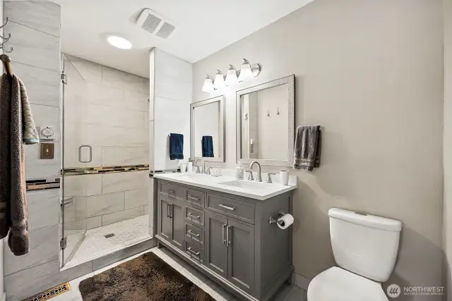 Dual vanity and custom tile shower.