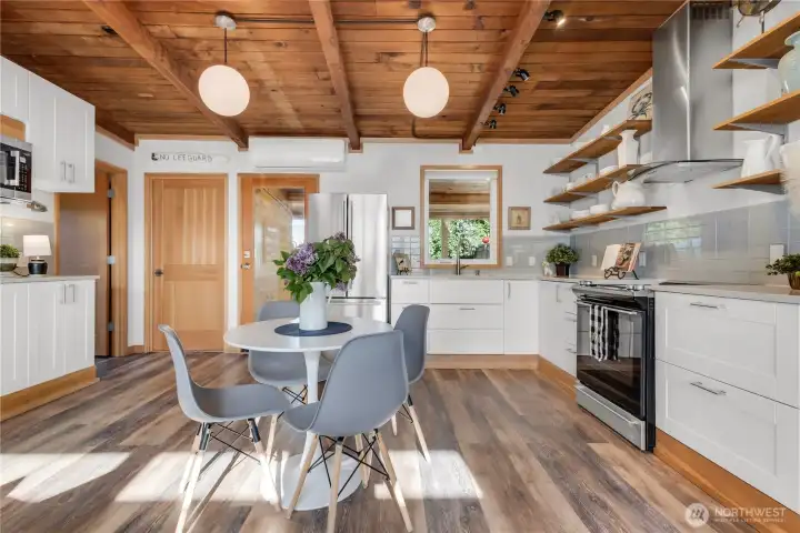 Beautiful great room with original fir vaulted ceilings and waterproof laminate wood plank flooring! Ductless HP for Cooling and Heating! Tankless hot water!