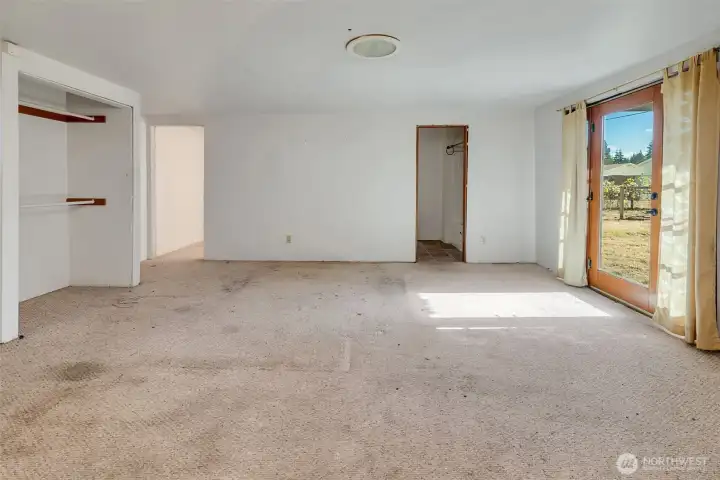 Primary bedroom with ensuite bathroom and direct access to the back yard