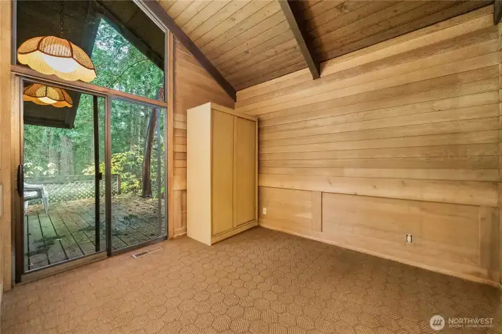 Bedroom 1 with sliding door and tall ceilings