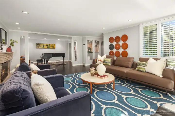 A gas fireplace with original midcentury stone surround separates the living room and baby-grand-sized additional room beyond.  This space is just as adept at throwing down for a large group with style as it is enveloping you in cozy goodness with a cup of tea and a good book.