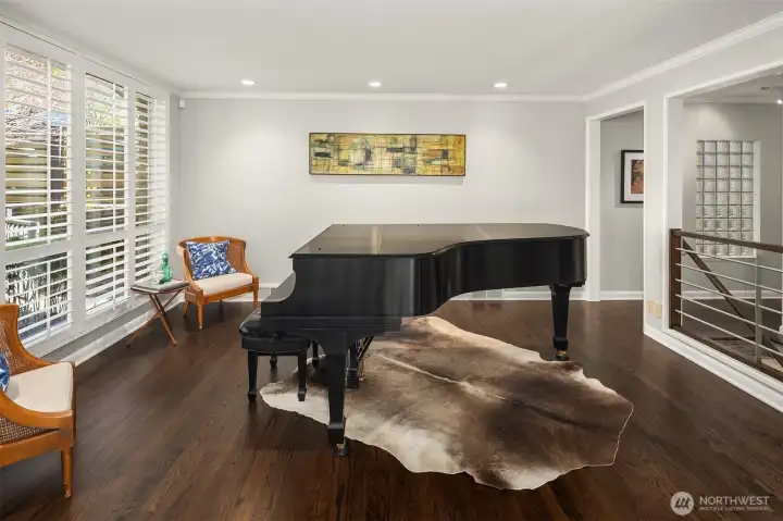 Even if you don't play piano you will appreciate this space.  Windows face north for soft/diffuse all-day light.  Stairs lead to the lower level, and the hall takes you to the dining room, kitchen, and 2 beds/1.75 baths.