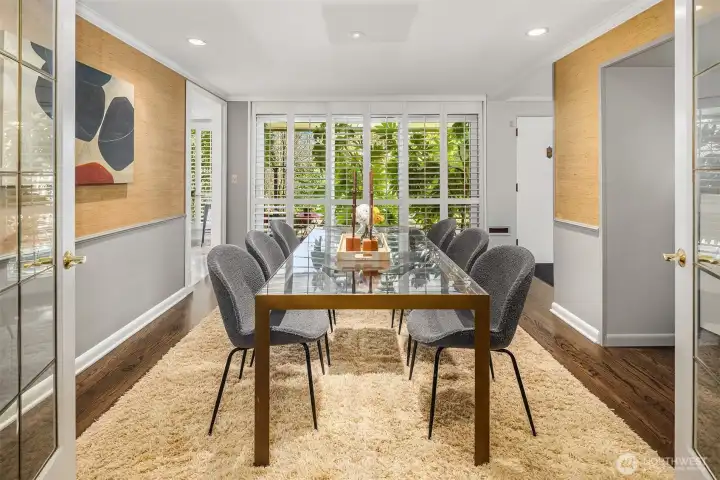 A sliding door is tucked behind the louvered wooden shades off the dining room, leading out to the front patio.  Let's take a quick peek...
