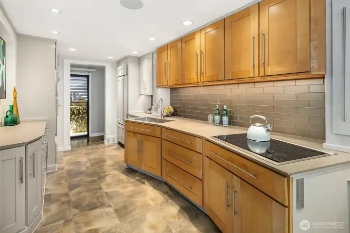 The well-designed kitchen offers abundant counter and cabinet space, with nice finishes and an abundance of natural light.