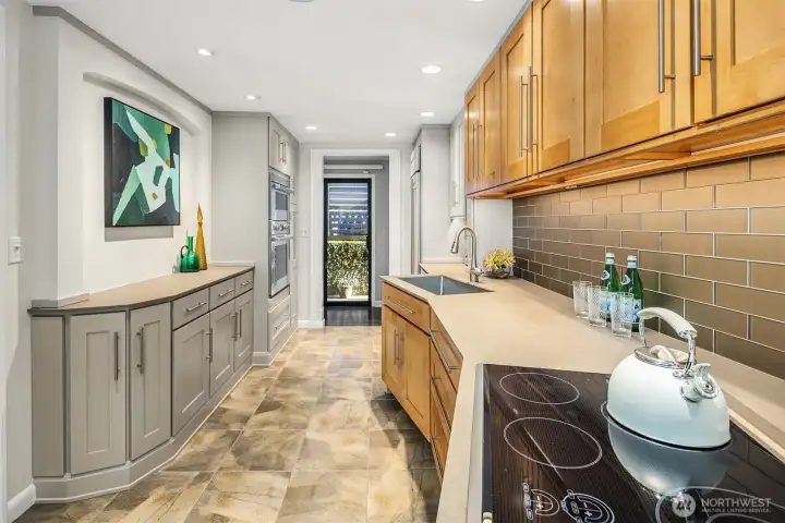 The slider to the front patio is just to our left out of frame.  The door straight ahead leads to a sweet side patio with planting beds, let's take a look...