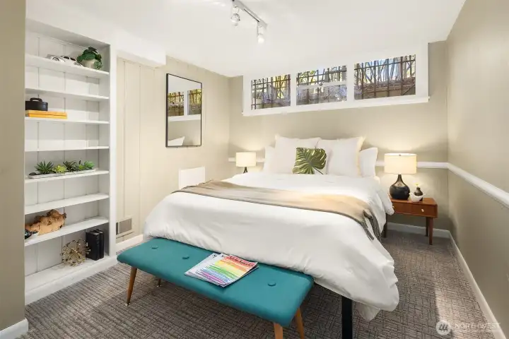 The lower level 3rd bedroom is non-conforming due to the current window size and height from the ground; but has nice ceiling height, a built-in bookcase, and closet (just out of frame on the left.)