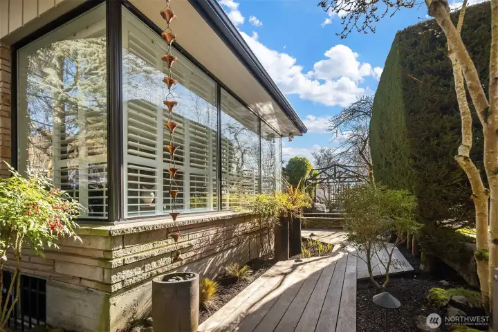 An Ipe wood walkway leads from the top of the front entry stairs to the front patio.