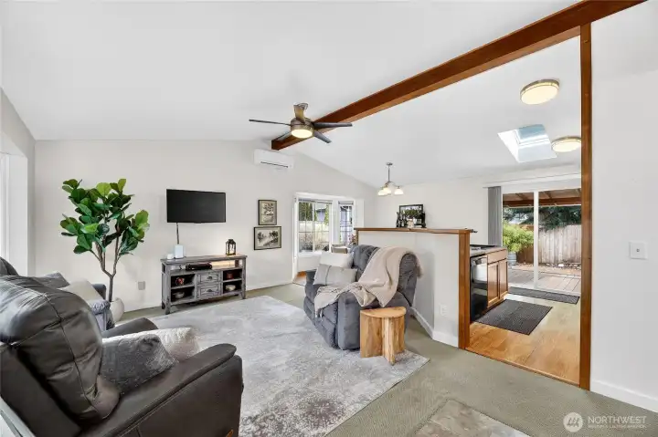 Light filled open concept living area w/ charming bay window