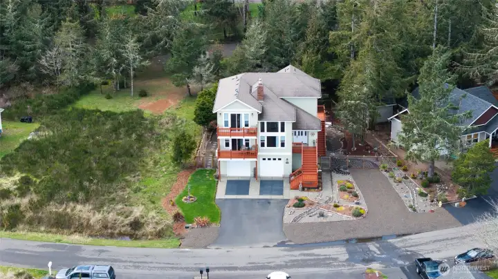 Fully landscaped all around, with paved driveway and RV parking with hookups.