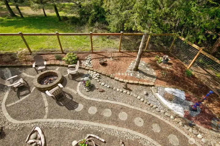 Back yard fire pit is a lovely gathering space for evening bonfires and socializing.