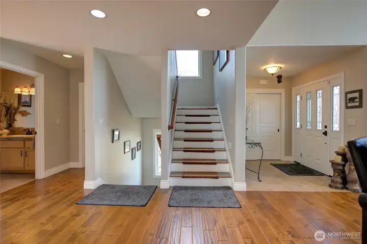 Coming through the front door to main floor, you will find the dining room, great room, kitchen, living room, half bath, laundry room, and stairs to bedrooms and garage.