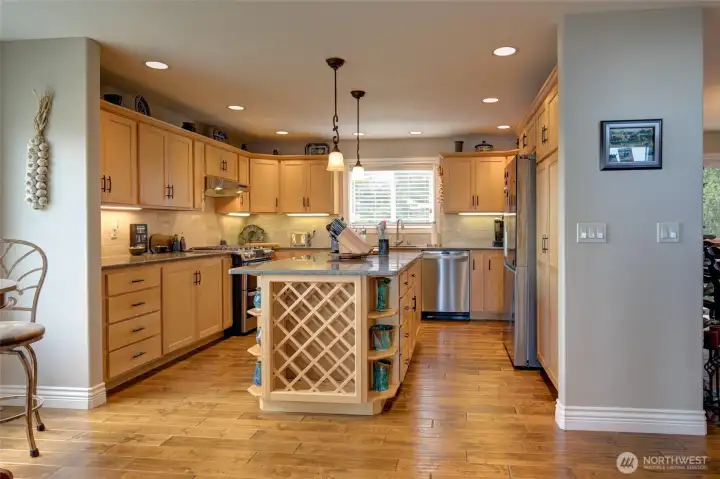 Gorgeous maple cabinets with soft close feature, large island and pantry wall are key attributes in the kitchen.