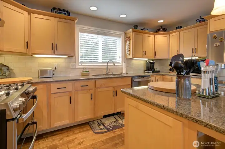 Granite countertops, tile backsplash, and under cabinet lighting are touches that add a sense of luxury.