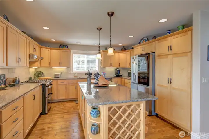 Pantry wall with pull out drawers, and wine rack on end of the island.
