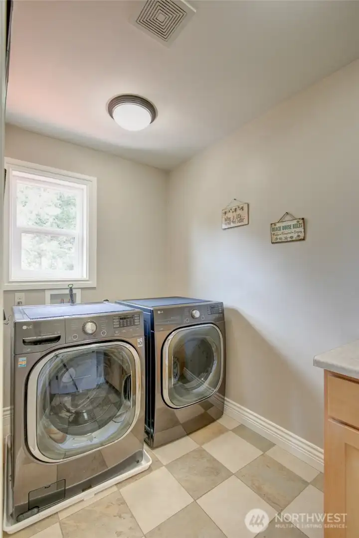 ...a spacious laundry room with utility sink.