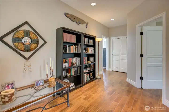 At the top of the stairs, you are greeted by a spacious hallway to the primary suite, two bedrooms, a full bath, and large linen closet.